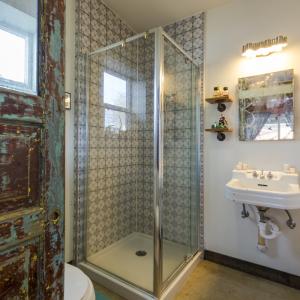 Bathroom w/ tile surround and rustic fixtures