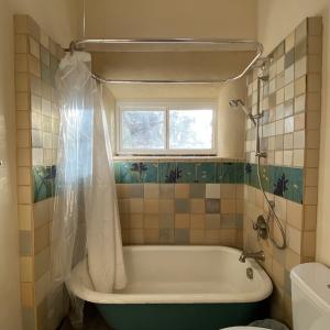 handmade tile surround for clawfoot tub w/ clay plaster