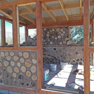 Progress photo highlighting patterning of mesquite and pine wood on back wall.